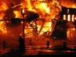 firefighter fighting burning hous