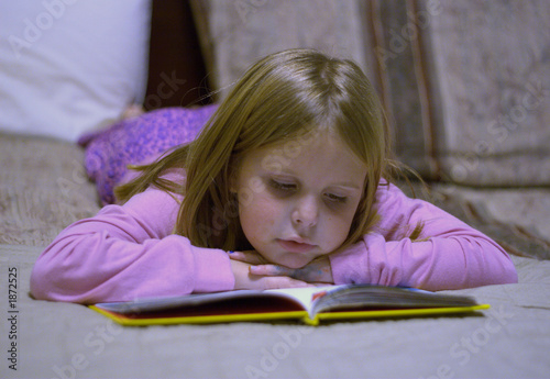 Photo: child reading on bed child reading on bed