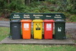 five rubbish bins in a row