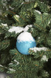 bauble hanging on a christmas tree covered with s bauble hanging on a christmas tree covered with s