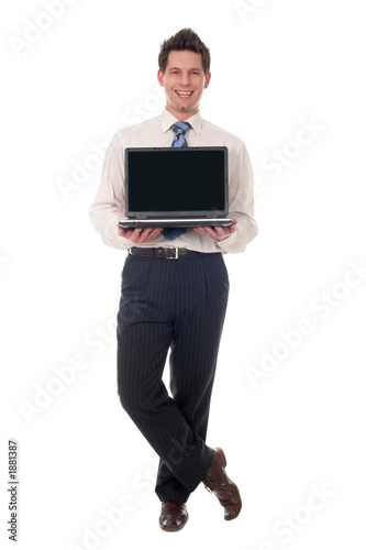 businessman holding laptop, smiling