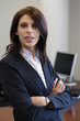 positive woman executive in his office portrait