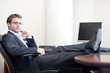 positive junior executive in his office portrait
