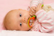 an infant playing with her rattle.