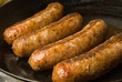 sausages in a black frying pan sausages in a black frying pan
