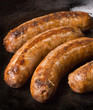 sausages in a black frying pan sausages in a black frying pan