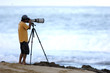 man taking photo on beach
