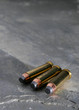 pistol bullets on slate