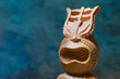 tiki statue on blue background