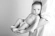 baby sitting in daddy's arms