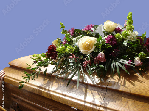 casket with flowers, blue sky