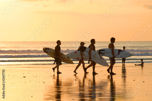 surfers at sunset