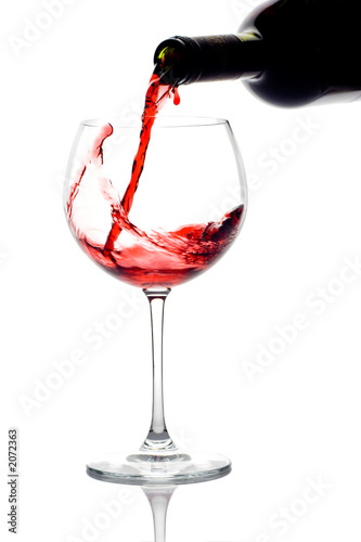 red wine pouring down from a wine bottle