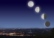 night cityscape with moon phases