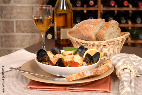 Photo: bowl of seafood soup with wine and rustic bread bowl of seafood soup with wine and rustic bread
