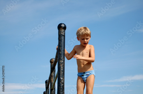 Leinwandbild Motiv small boy and clear blue sky