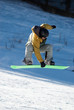 flying snowboarder on green board