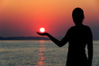 a girl holding the sun