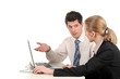 businesswoman and businessman sitting at desk with