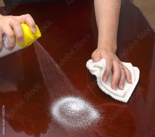 Photo: hands polishing a wooden table hands polishing a wooden table