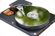 hard disk reflecting green on a white background