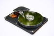 hard disk reflecting green on a white background