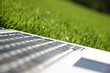 silver laptop showing keyboard on green grass silver laptop showing keyboard on green grass
