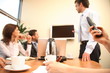 man making presentation on tv screen to the group