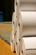 white rolls of printing paper on a loading dock white rolls of printing paper on a loading dock