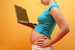 happy pregnancy - pregnant woman browsing on inter