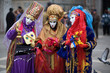 three people are dressed for the carnivale in veni three people are dressed for the carnivale in veni