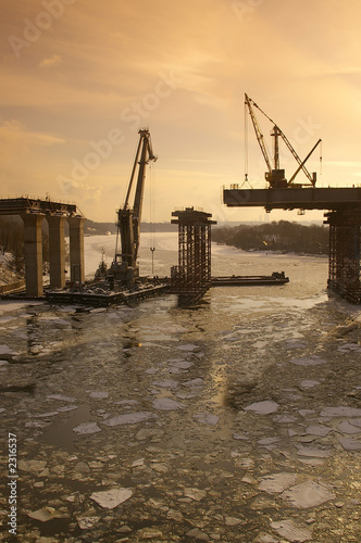 Photo: the bridge through the winter river the bridge through the winter river