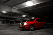 red hatchback car on black and white background red hatchback car on black and white background