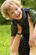 happy child on hands of careful mum
