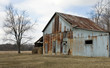 rusty barn, bare tree