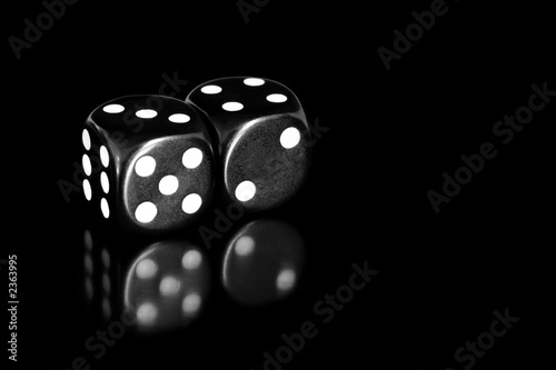 black and white dice reflected on black