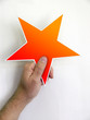 hand holding orange red star hand holding orange red star