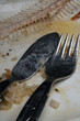 knife and fork on dirty plate wth fishbone
