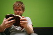 young man reading small bible