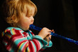 blond girl playing blue flute