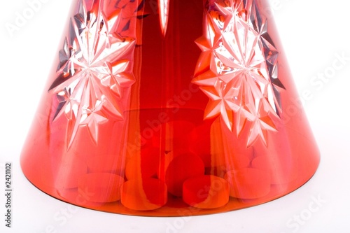 Photo: pills in a red glass. pills in a red glass.