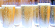 group of champagne glasses filled with bubbles