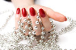 woman hand and silver beads woman hand and silver beads