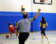 referee making a call at a girls basketball game referee making a call at a girls basketball game
