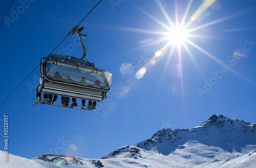 Photo: skiers in a chairlift skiers in a chairlift