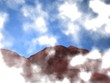 clouds in the sky in front of the mountains