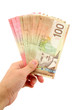 hand holding canadian dollars