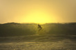 sunset surfer cross a wave