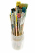 used paintbrushes in a glass