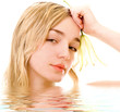 beautiful blonde girl with lily in the bath